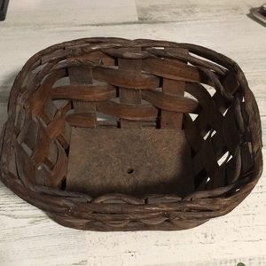 Heavy wooden bottom small brown basket with hole in bottom of wood.